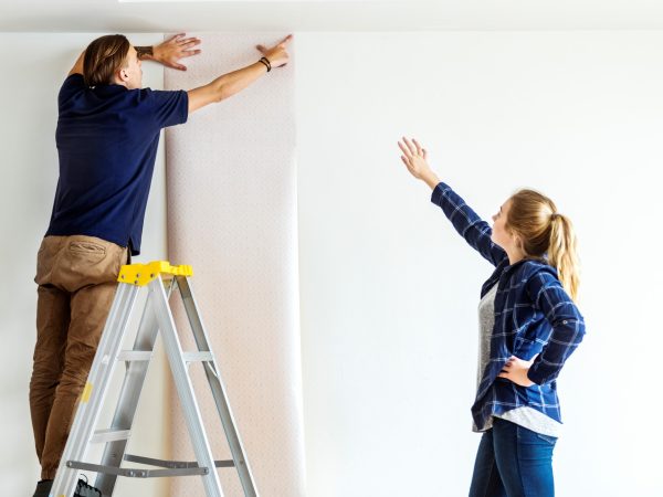 Couple choosing house wallpaper